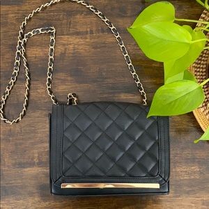 Black quilted purse with gold chain detailing